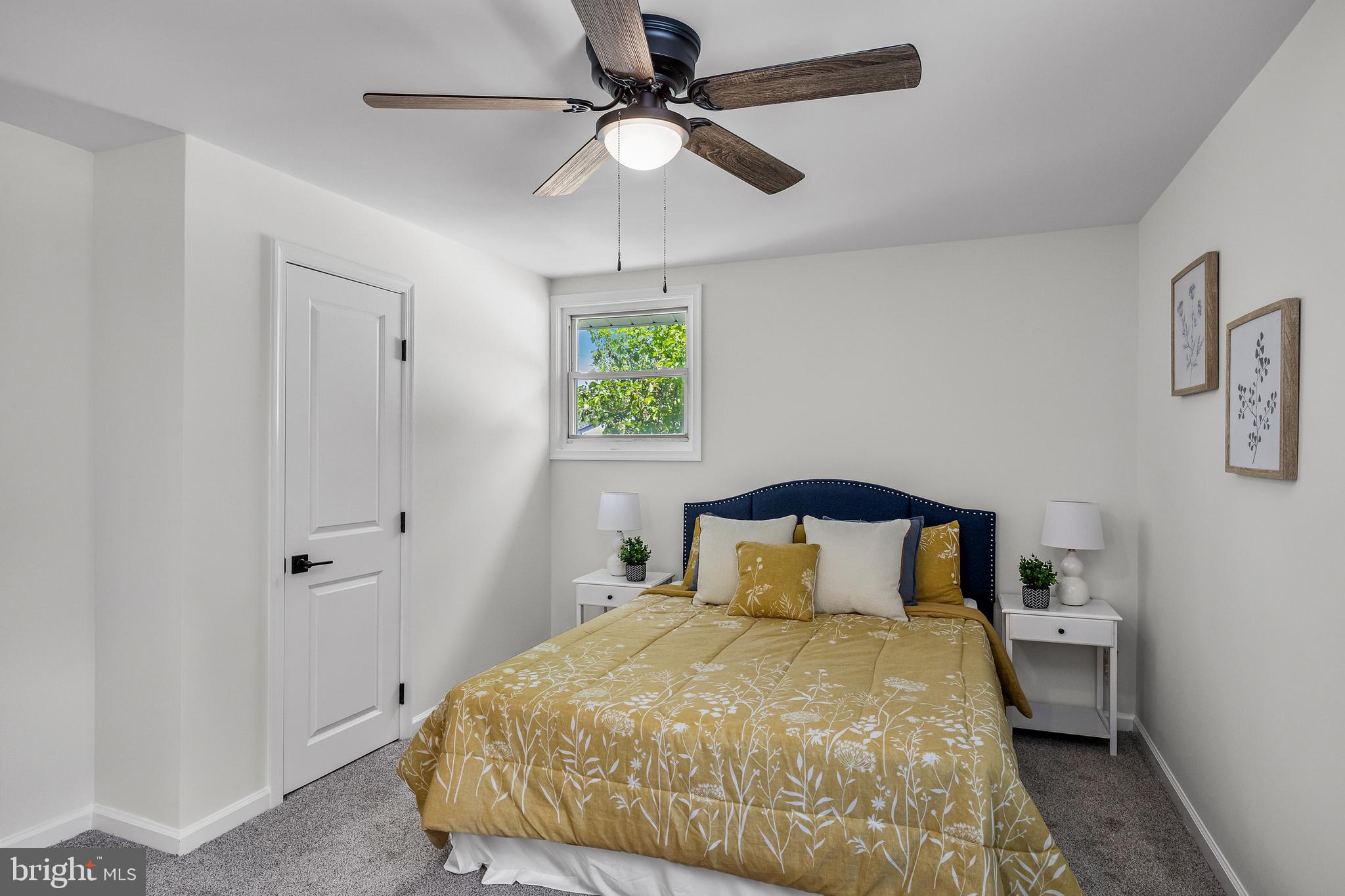 219 Somerset Road Woodbury, NJ 08096 - Photo 11 of 13 a bedroom with a bed and a chandelier