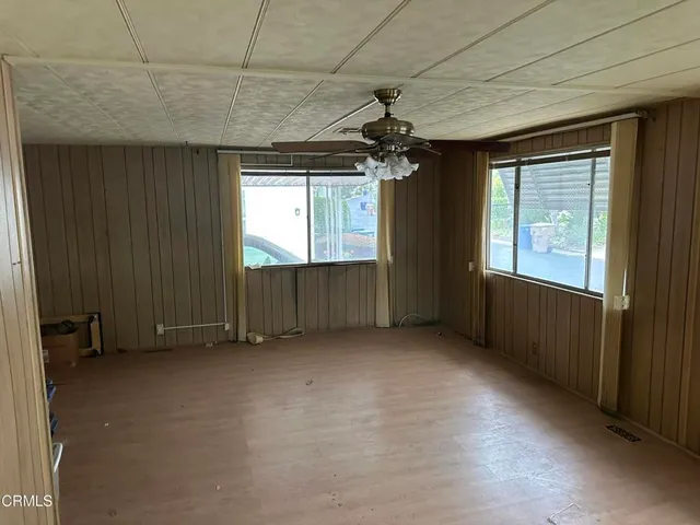 a view of a room with wooden floor and windows