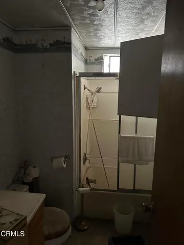 a bathroom with a toilet and a shower