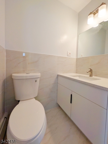 39 Church Street, Unit A Millburn, NJ 07041 - Photo 12 of 14 a bathroom with a toilet sink and mirror