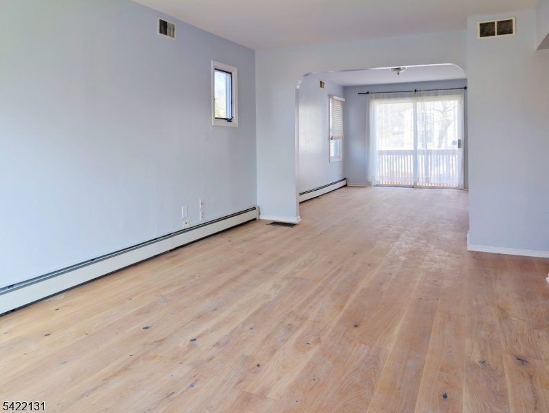 39 Church Street, Unit A Millburn, NJ 07041 - Photo 3 of 14 an empty room with wooden floor and windows