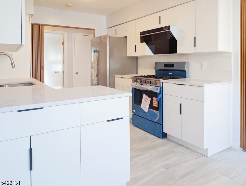 39 Church Street, Unit A Millburn, NJ 07041 - Photo 5 of 14 a kitchen with stainless steel appliances a refrigerator stove and sink