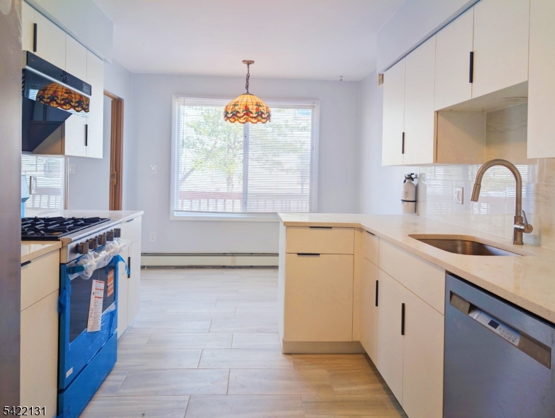 39 Church Street, Unit A Millburn, NJ 07041 - Photo 7 of 14 a kitchen that has a sink cabinets appliances and a window