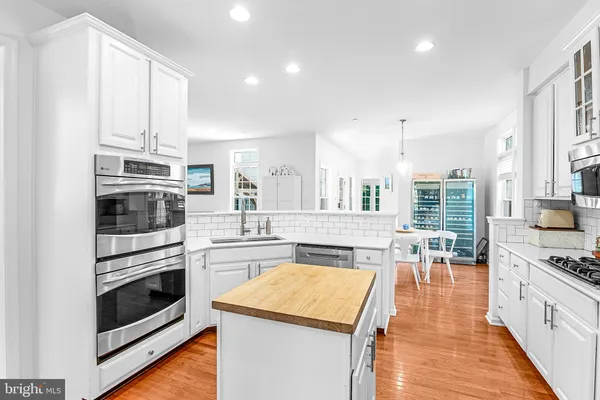 a view of a patio with table and chairs potted plants with wooden floor
