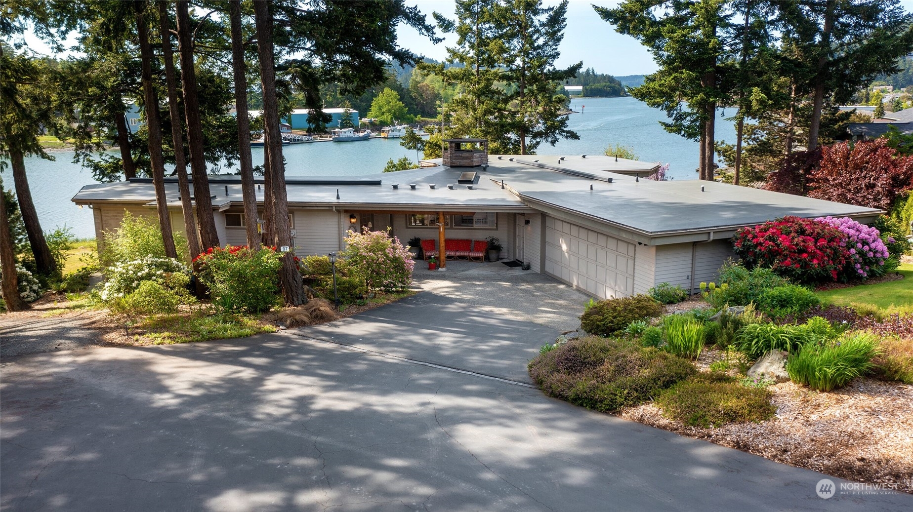 97 Samish Place La Conner, WA 98257 - Photo 2 of 40 a view of a house with a yard and potted plants