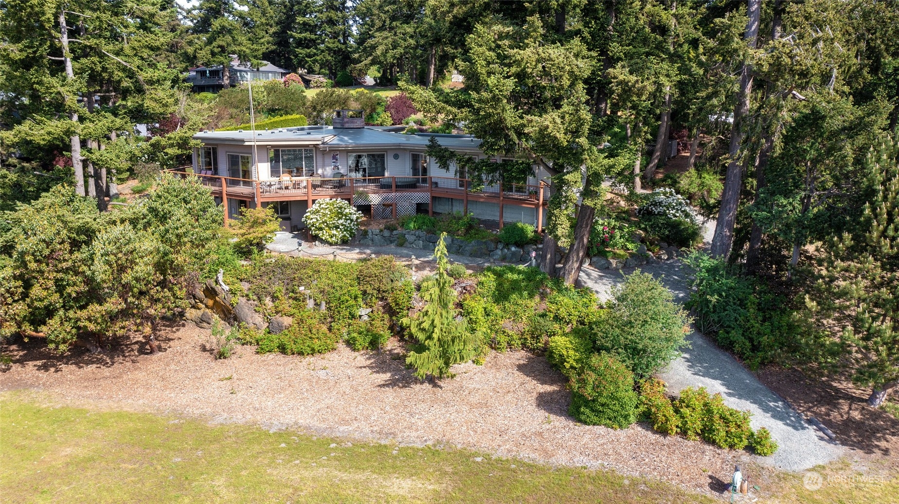 97 Samish Place La Conner, WA 98257 - Photo 26 of 40 a view of a house with a yard and potted plants