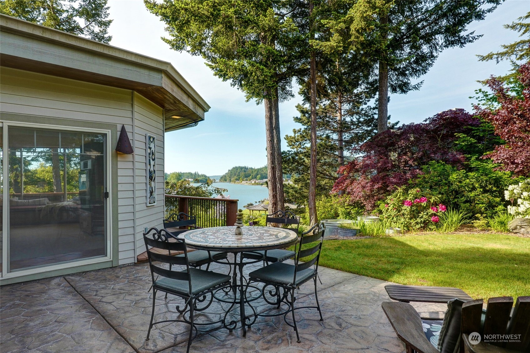 97 Samish Place La Conner, WA 98257 - Photo 32 of 40 a view of a table and chairs in patio with a yard