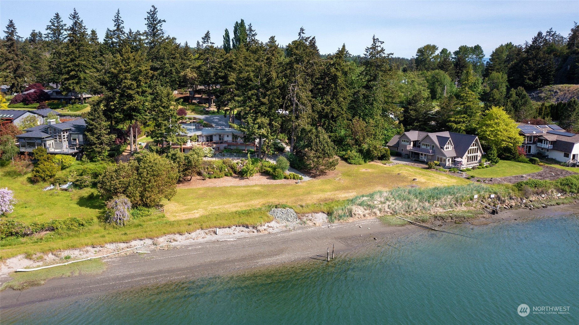 97 Samish Place La Conner, WA 98257 - Photo 36 of 40 a view of a house with a yard and trees