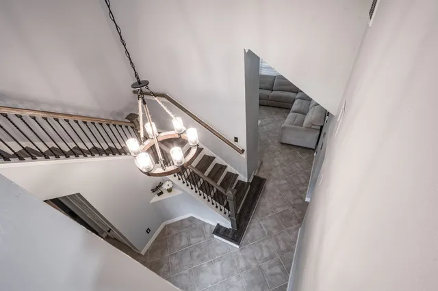 a bedroom with a large bed and a chandelier