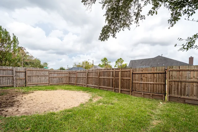 a view of backyard of house with green space
