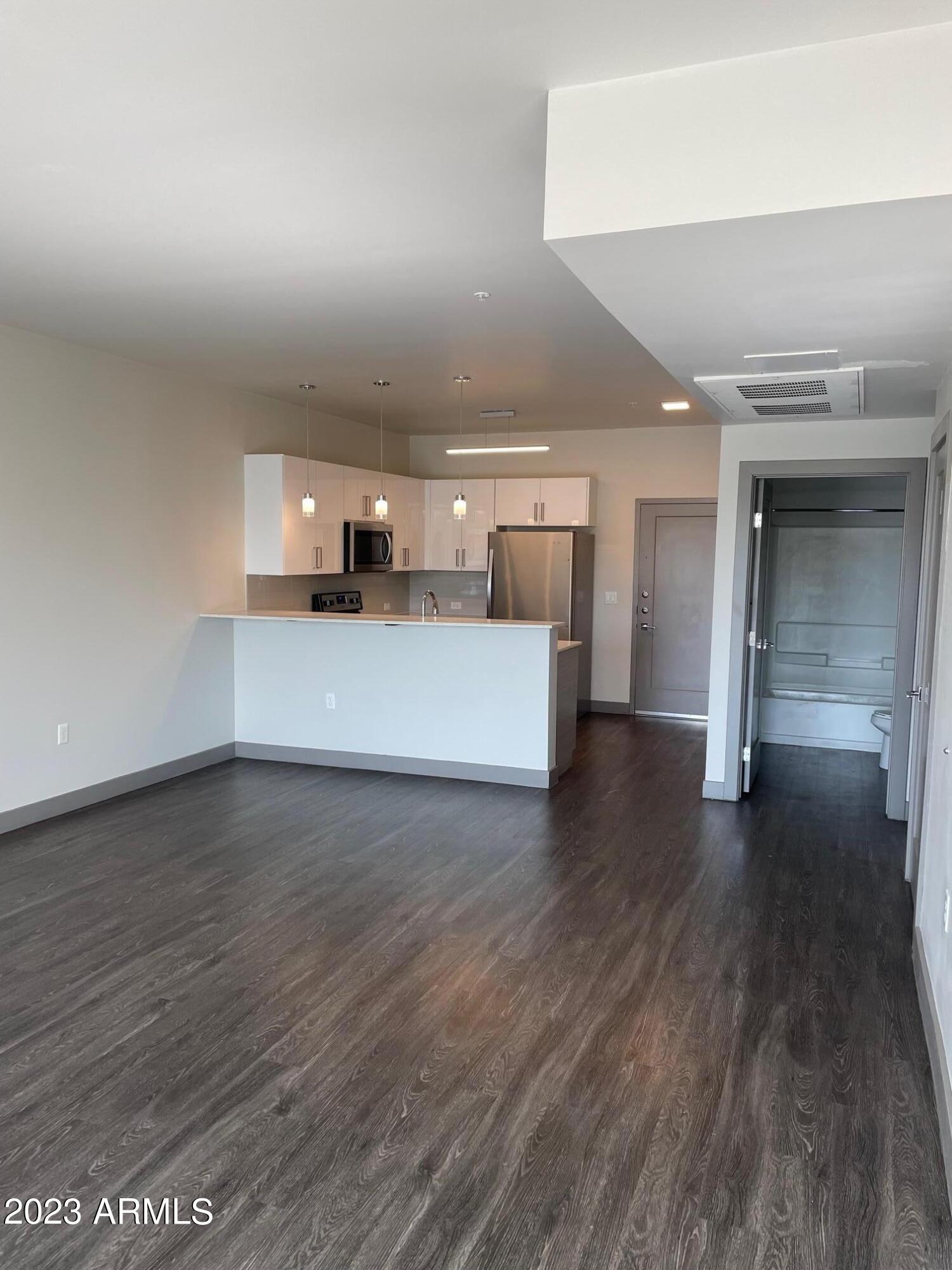 425 West Osborn Road, Unit 213 Phoenix, AZ 85013 - Photo 9 of 29 a view of a kitchen with a sink and a refrigerator