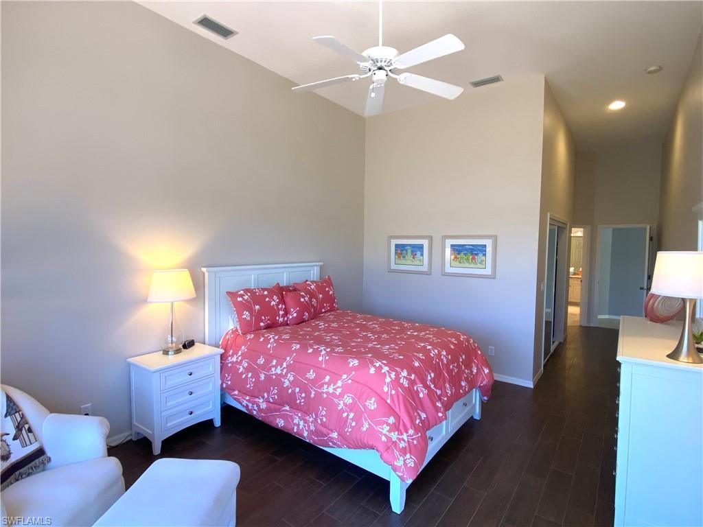 19307 Silver Oak Drive Estero, FL 33967 - Photo 15 of 43 a bedroom with a bed and a chandelier