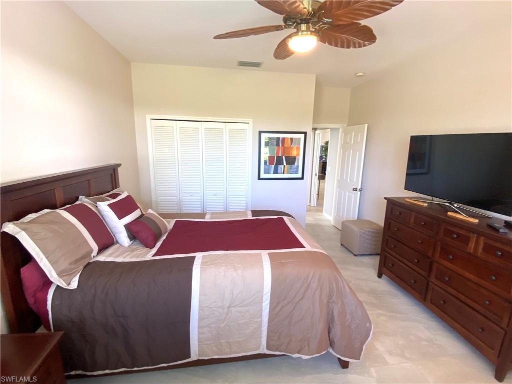 19307 Silver Oak Drive Estero, FL 33967 - Photo 26 of 43 a bedroom with a bed and a flat screen tv