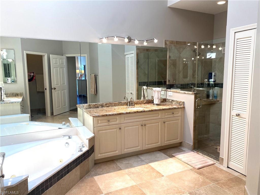 19307 Silver Oak Drive Estero, FL 33967 - Photo 29 of 43 a bathroom with a sink double vanity granite and a shower