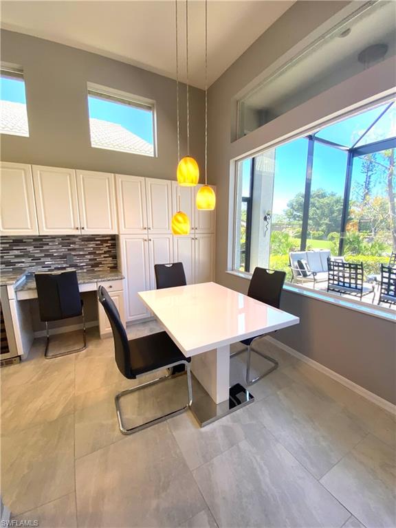 19307 Silver Oak Drive Estero, FL 33967 - Photo 34 of 43 a swimming pool with a table and chairs