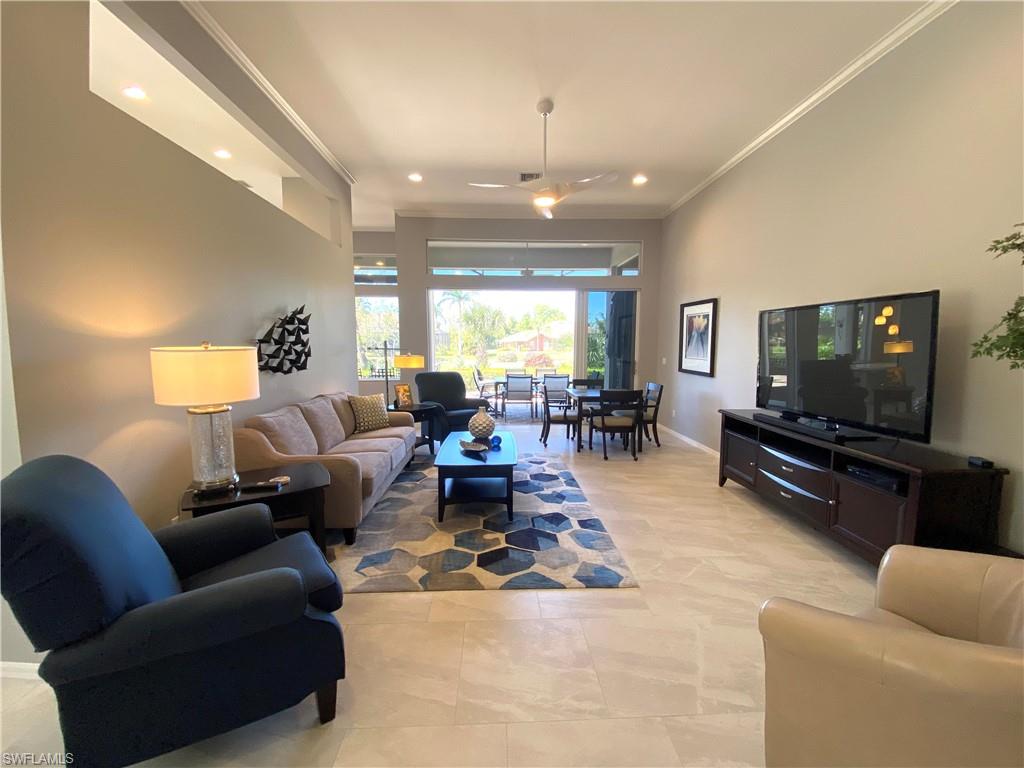 19307 Silver Oak Drive Estero, FL 33967 - Photo 6 of 43 a living room with furniture and a flat screen tv