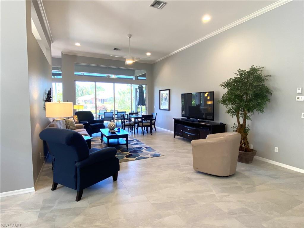19307 Silver Oak Drive Estero, FL 33967 - Photo 8 of 43 a living room with furniture and a flat screen tv