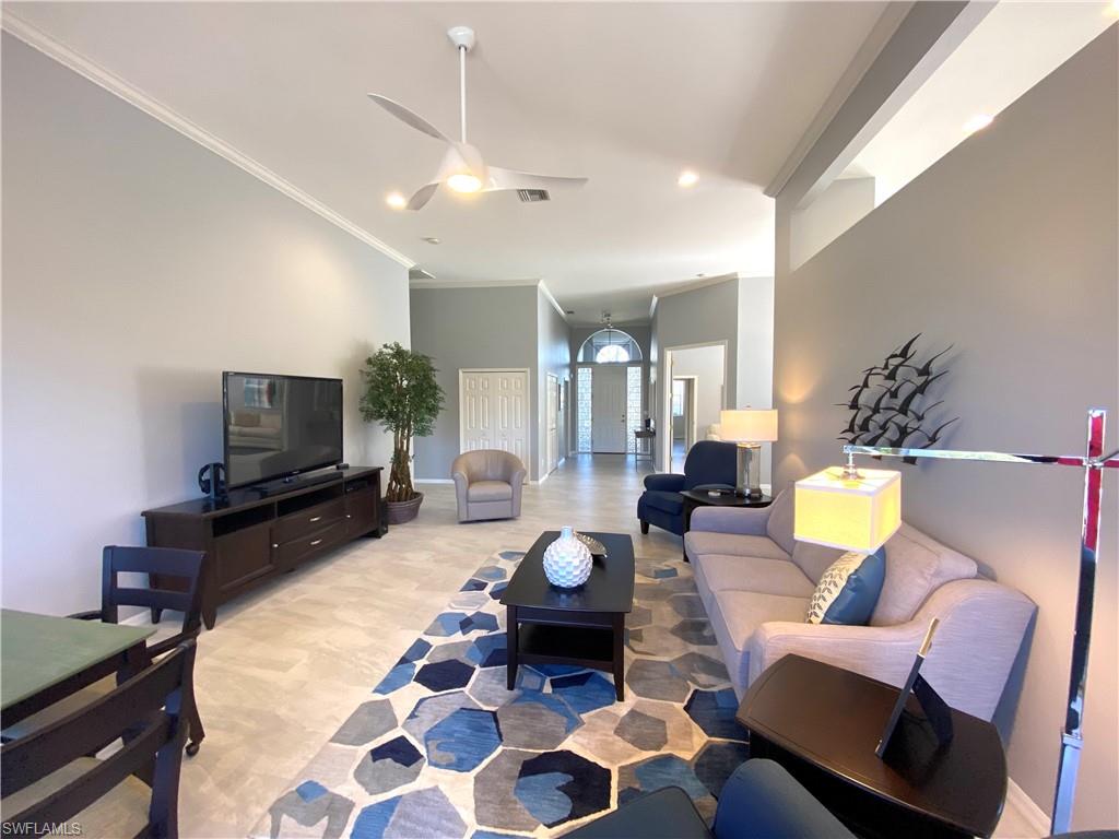 19307 Silver Oak Drive Estero, FL 33967 - Photo 9 of 43 a living room with furniture and a flat screen tv