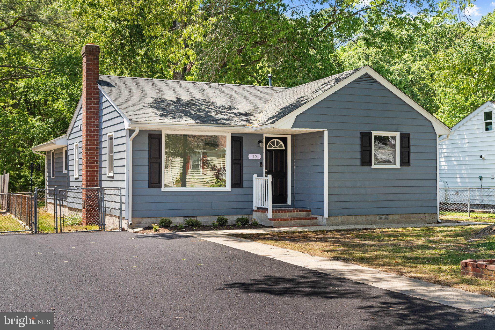Charming blue home with inviting porch.