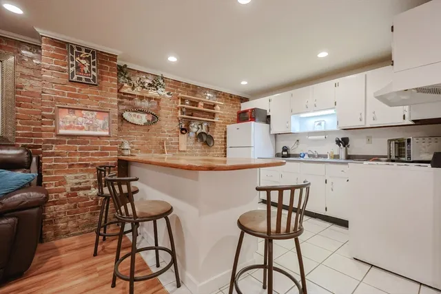 a kitchen with stainless steel appliances a table and chairs in it