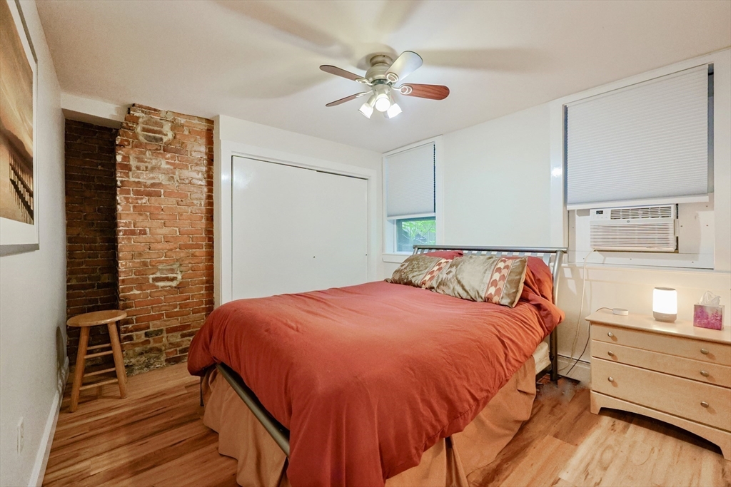 33 Inman Street, Unit 1B Cambridge, MA 02139 - Photo 10 of 12 a bedroom with a bed and cabinets