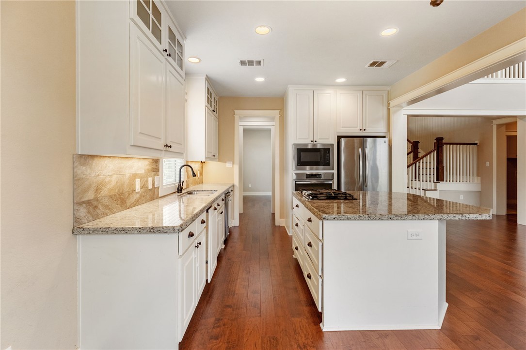 2136 Rockcliffe Loop College Station, TX 77845 - Photo 17 of 48 a kitchen with stainless steel appliances granite countertop a sink and a refrigerator