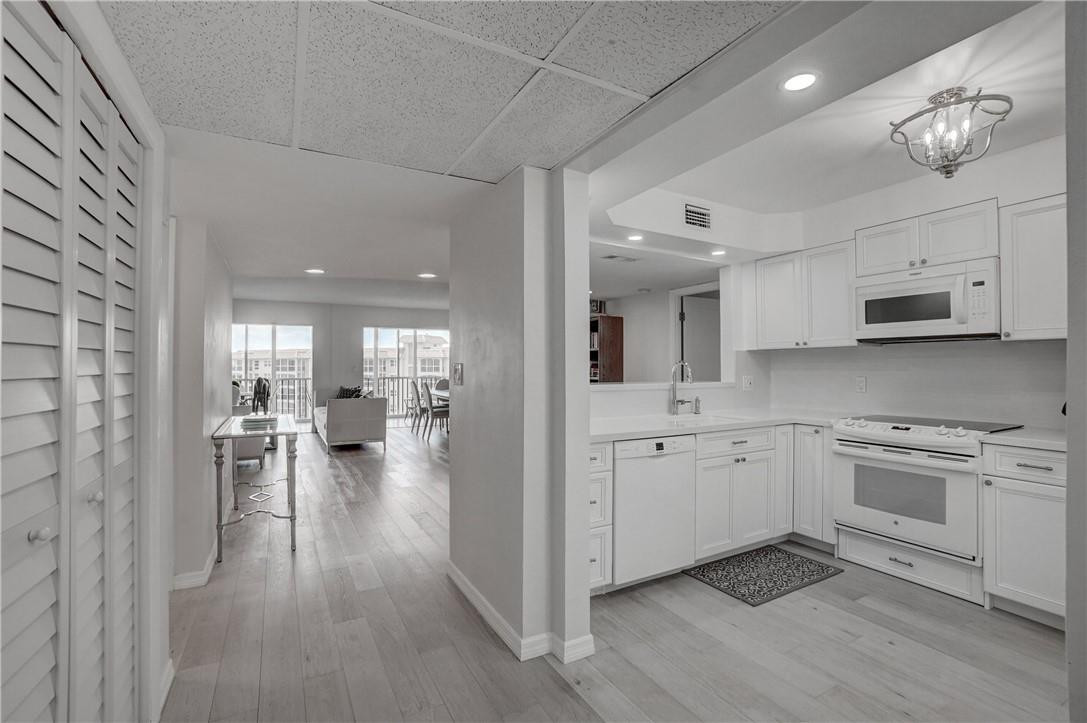 2871 North Ocean Boulevard, Unit C519 Boca Raton, FL 33431 - Photo 1 of 36 a kitchen with white cabinets and sink