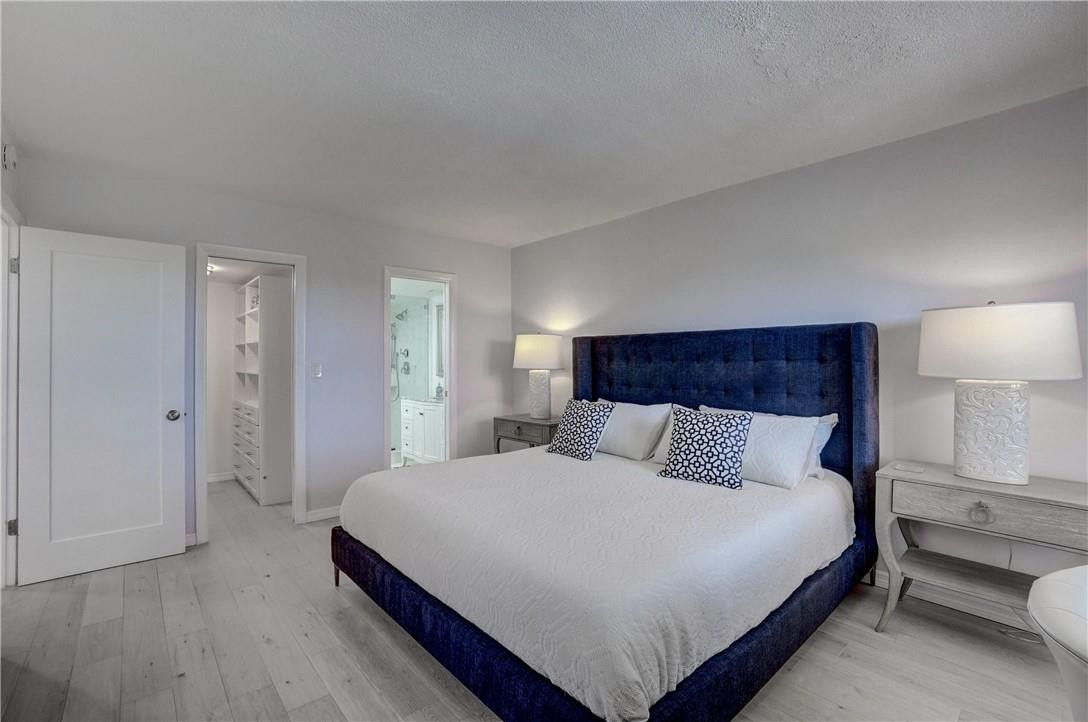 2871 North Ocean Boulevard, Unit C519 Boca Raton, FL 33431 - Photo 18 of 36 a bedroom with a bed and a lamp