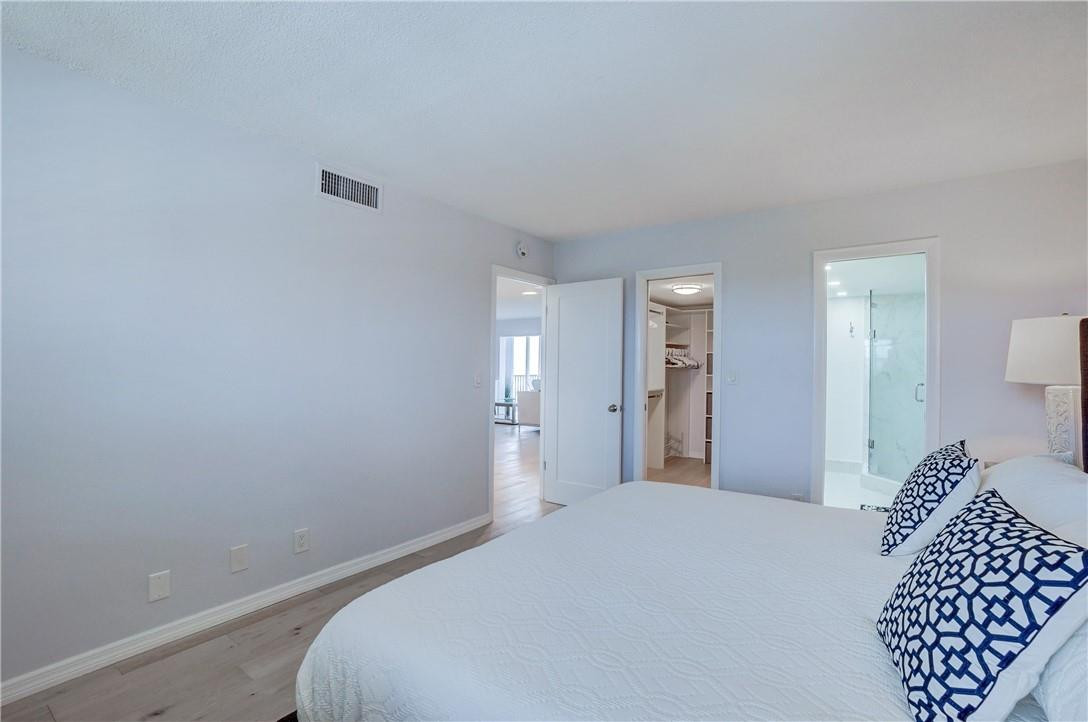 2871 North Ocean Boulevard, Unit C519 Boca Raton, FL 33431 - Photo 19 of 36 a bedroom with a bed and a walk in closet