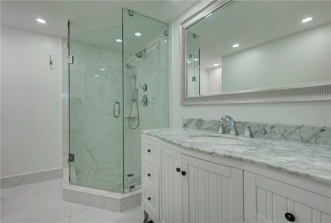2871 North Ocean Boulevard, Unit C519 Boca Raton, FL 33431 - Photo 21 of 36 a bathroom with a granite countertop sink mirror and shower