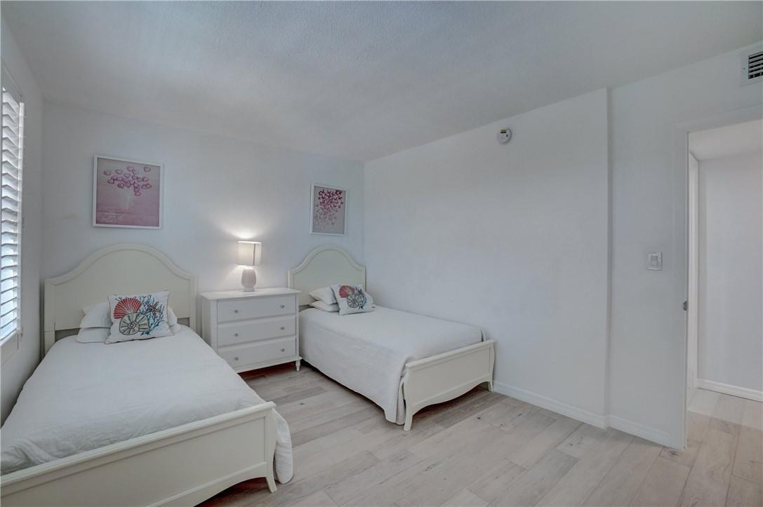 2871 North Ocean Boulevard, Unit C519 Boca Raton, FL 33431 - Photo 24 of 36 a bedroom with two beds and painted walls