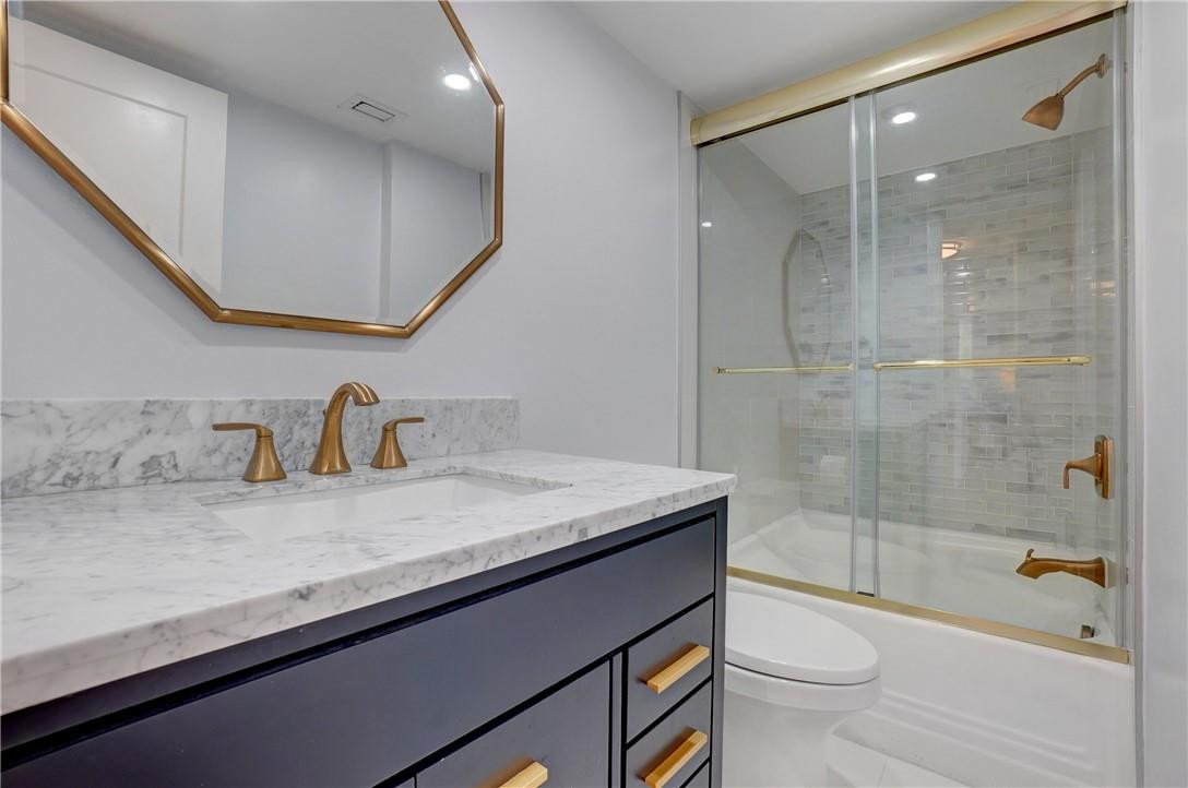 2871 North Ocean Boulevard, Unit C519 Boca Raton, FL 33431 - Photo 25 of 36 a bathroom with a granite countertop sink a toilet a mirror and bathtub