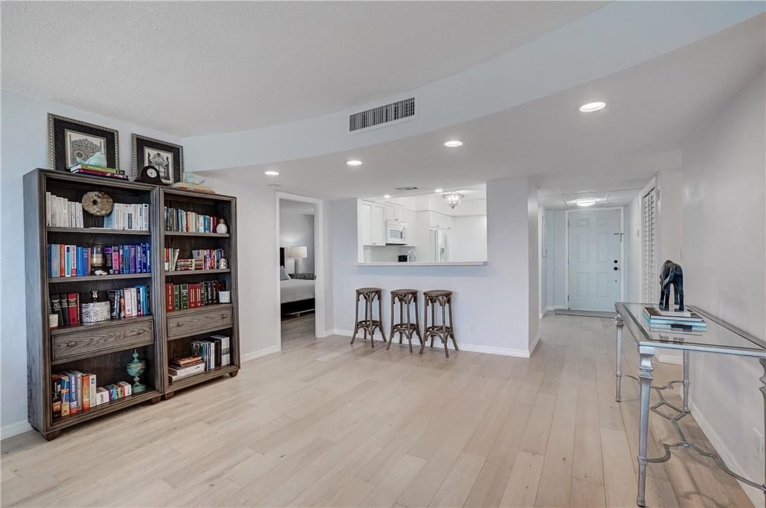 2871 North Ocean Boulevard, Unit C519 Boca Raton, FL 33431 - Photo 5 of 36 a view of a livingroom with furniture and a bookshelf