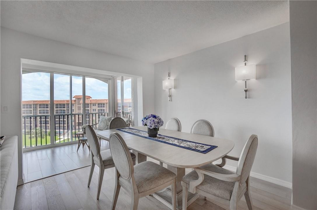2871 North Ocean Boulevard, Unit C519 Boca Raton, FL 33431 - Photo 7 of 36 a view of a dining room with furniture window and wooden floor