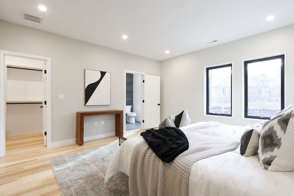 41 Nathan Road, Unit 1 Waltham, MA 02453 - Photo 17 of 25 a bedroom with a bed and a fireplace