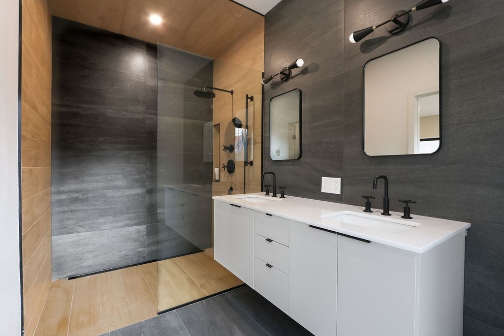 41 Nathan Road, Unit 1 Waltham, MA 02453 - Photo 18 of 25 a bathroom with a double vanity sink mirror and shower