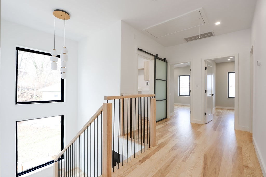 41 Nathan Road, Unit 1 Waltham, MA 02453 - Photo 20 of 25 a view of a hallway with wooden floor