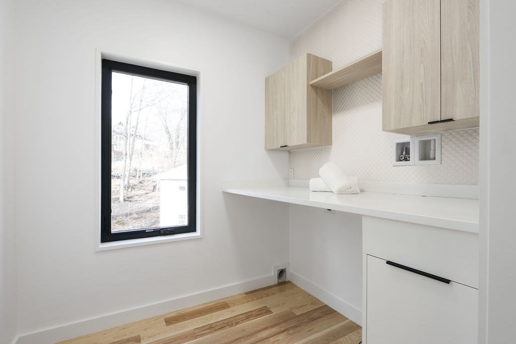 41 Nathan Road, Unit 1 Waltham, MA 02453 - Photo 21 of 25 a room with cabinets and wooden floor