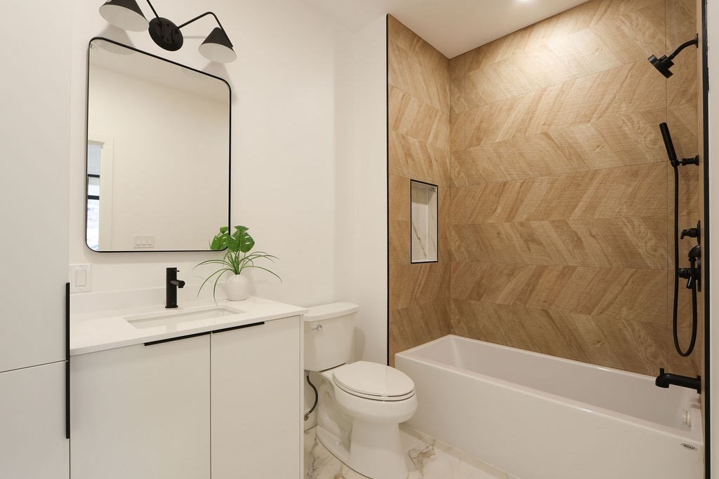 41 Nathan Road, Unit 1 Waltham, MA 02453 - Photo 23 of 25 a bathroom with a sink a toilet and shower