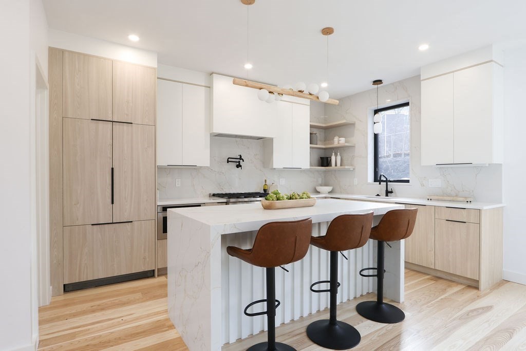 41 Nathan Road, Unit 1 Waltham, MA 02453 - Photo 4 of 25 a kitchen with stainless steel appliances granite countertop a sink a stove a refrigerator and white cabinets with wooden floor