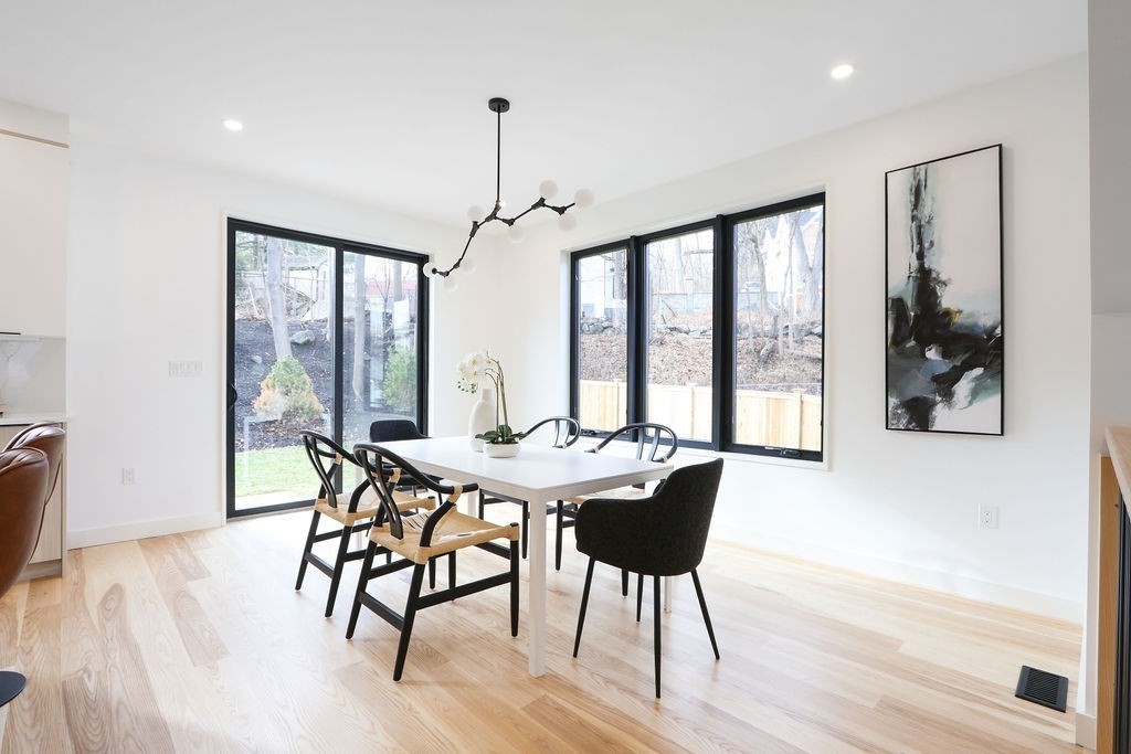 41 Nathan Road, Unit 1 Waltham, MA 02453 - Photo 6 of 25 a view of a dining room with furniture large windows and wooden floor