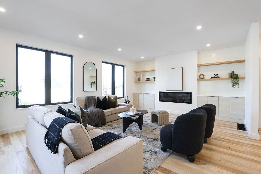 41 Nathan Road, Unit 1 Waltham, MA 02453 - Photo 10 of 25 a living room with furniture white walls and a fireplace