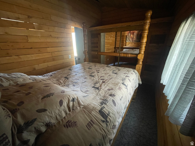 4648 West Taylor Flt Road Salina, UT 84654 - Photo 15 of 20 Wood-paneled interior walls characterize this space, featuring a built-in bed frame with turned wood posts