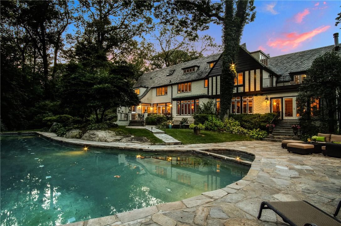 Sparkling 50' 2 lane lap pool and hot tub with access from the Sun Room, lower level Recreation Room and Dining Terrace.