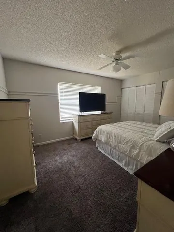 a bedroom with a bed and a television