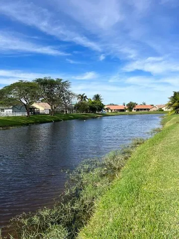 a view of a lake with houses in the back