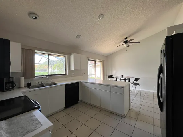 a large white kitchen with a large window