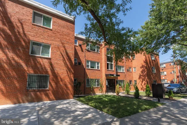 a view of a building with a yard