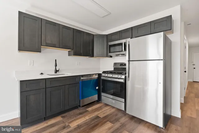 a kitchen with stainless steel appliances a refrigerator and a sink