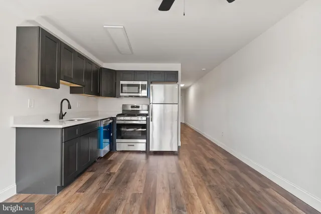 a kitchen with stainless steel appliances a refrigerator and a sink